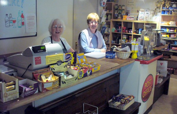 Volunteers serving at the Shop counter